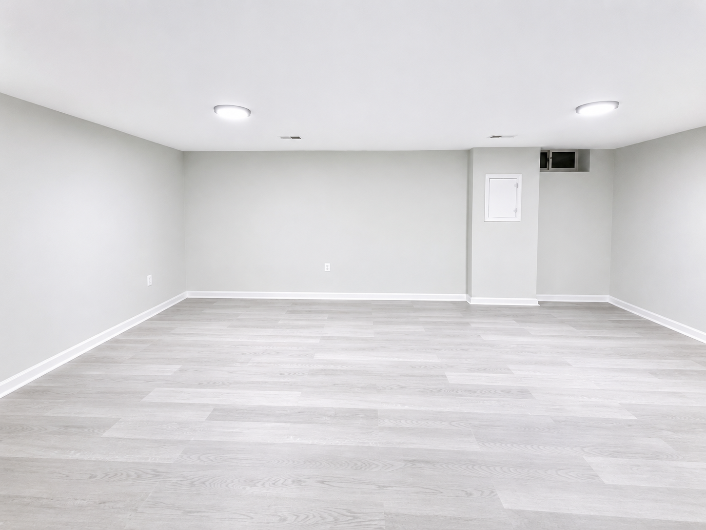 The Leeway Residence — Lower-level recreation room with luxury vinyl plank flooring