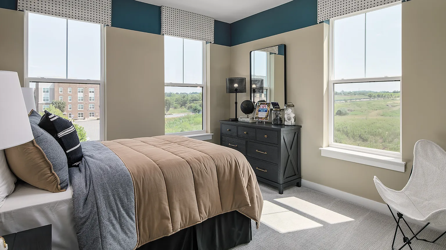 Second guest bedroom with three windows and open views at The Kincora Residence model home