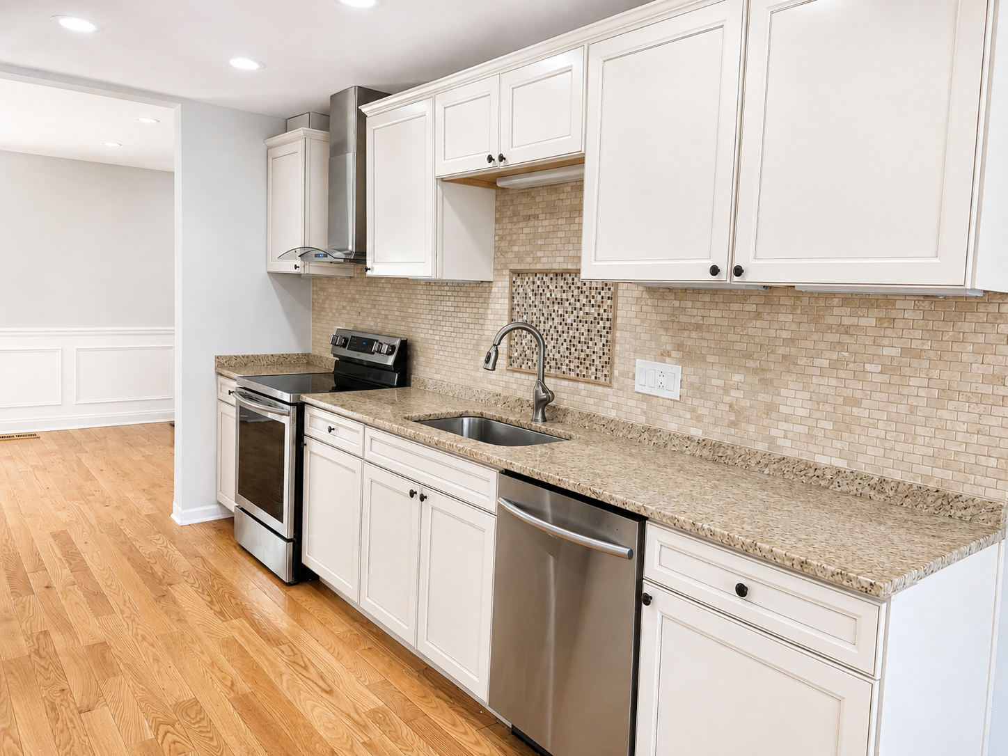 The Leeway Residence — Kitchen with granite counters, stainless steel appliances, and tile backsplash