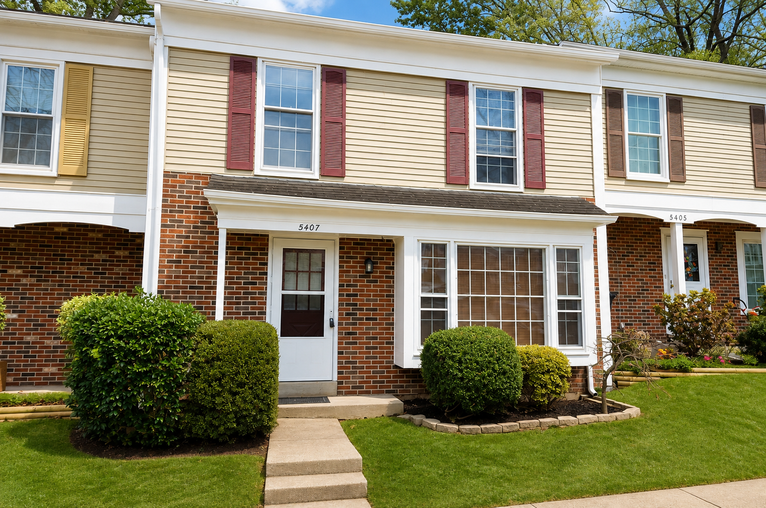 The Leeway Residence — Brick and siding exterior of The Leeway Residence townhome with landscaped entry