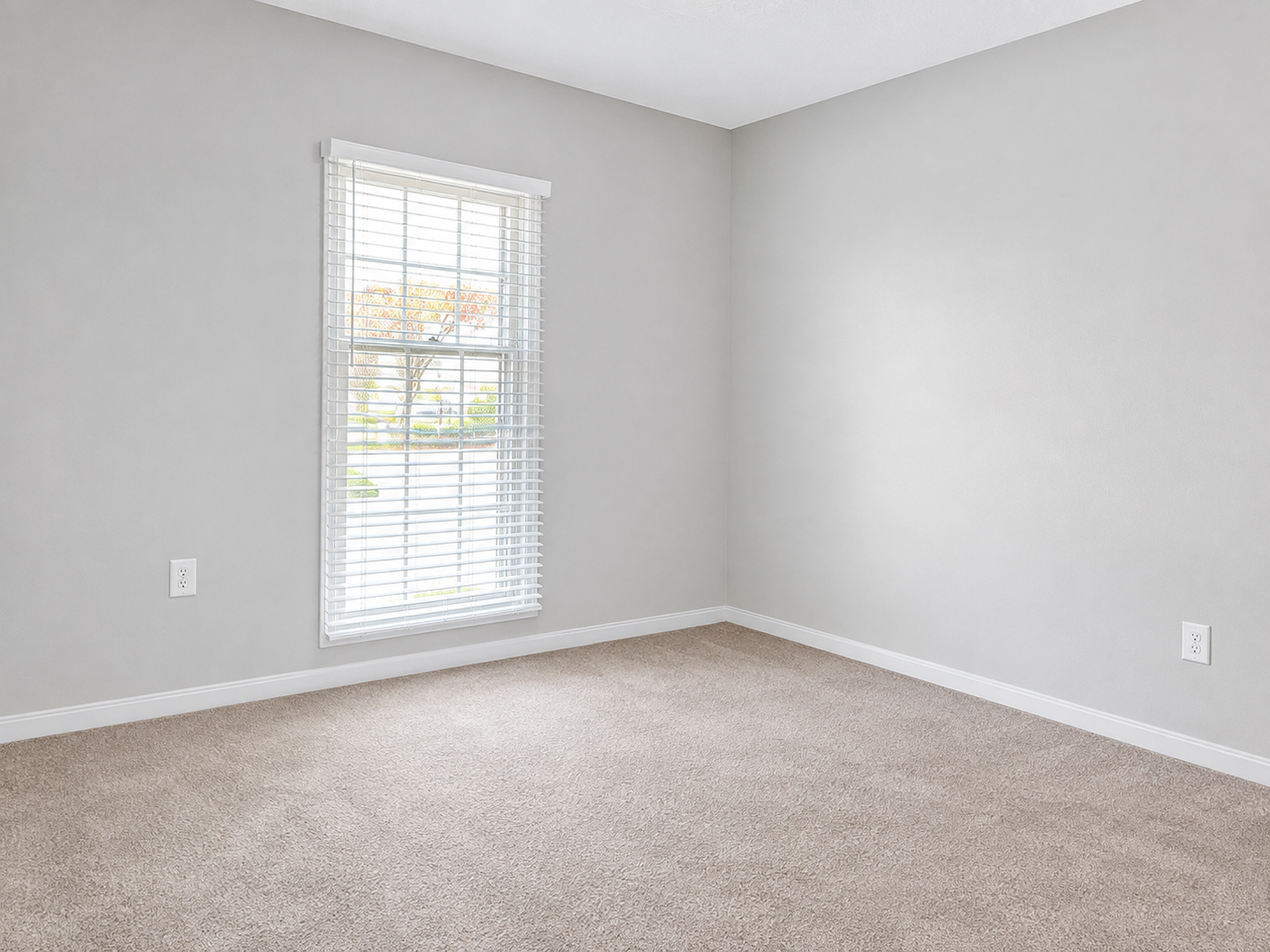 The Leeway Residence — Second bedroom with window and neutral carpet