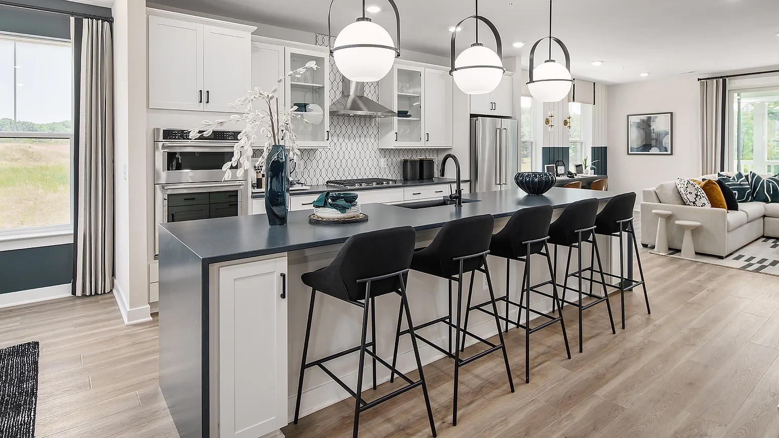 Kitchen island with seating opening to the living area at The Kincora Residence model home