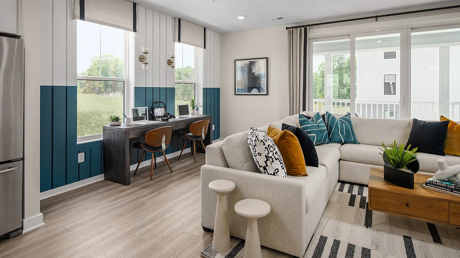 The Kincora Residence — Living area with built-in workspace and sliding doors to the lanai at The Kincora Residence model home